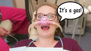 Woman breathing laughing gas.